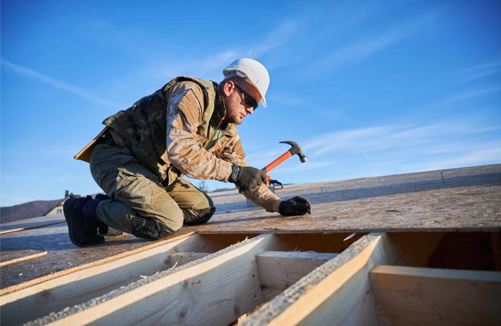 carpenter hammering nail into osb panel while buil 2023 11 27 05 32 58 utc